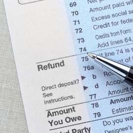 image of filling out tax refund papers